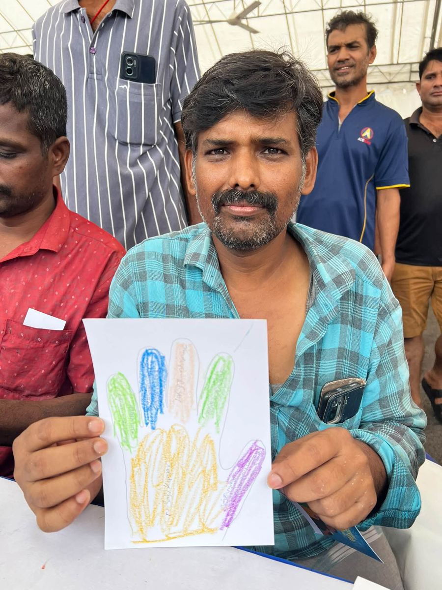 Portrait of [NAME] holding their artwork