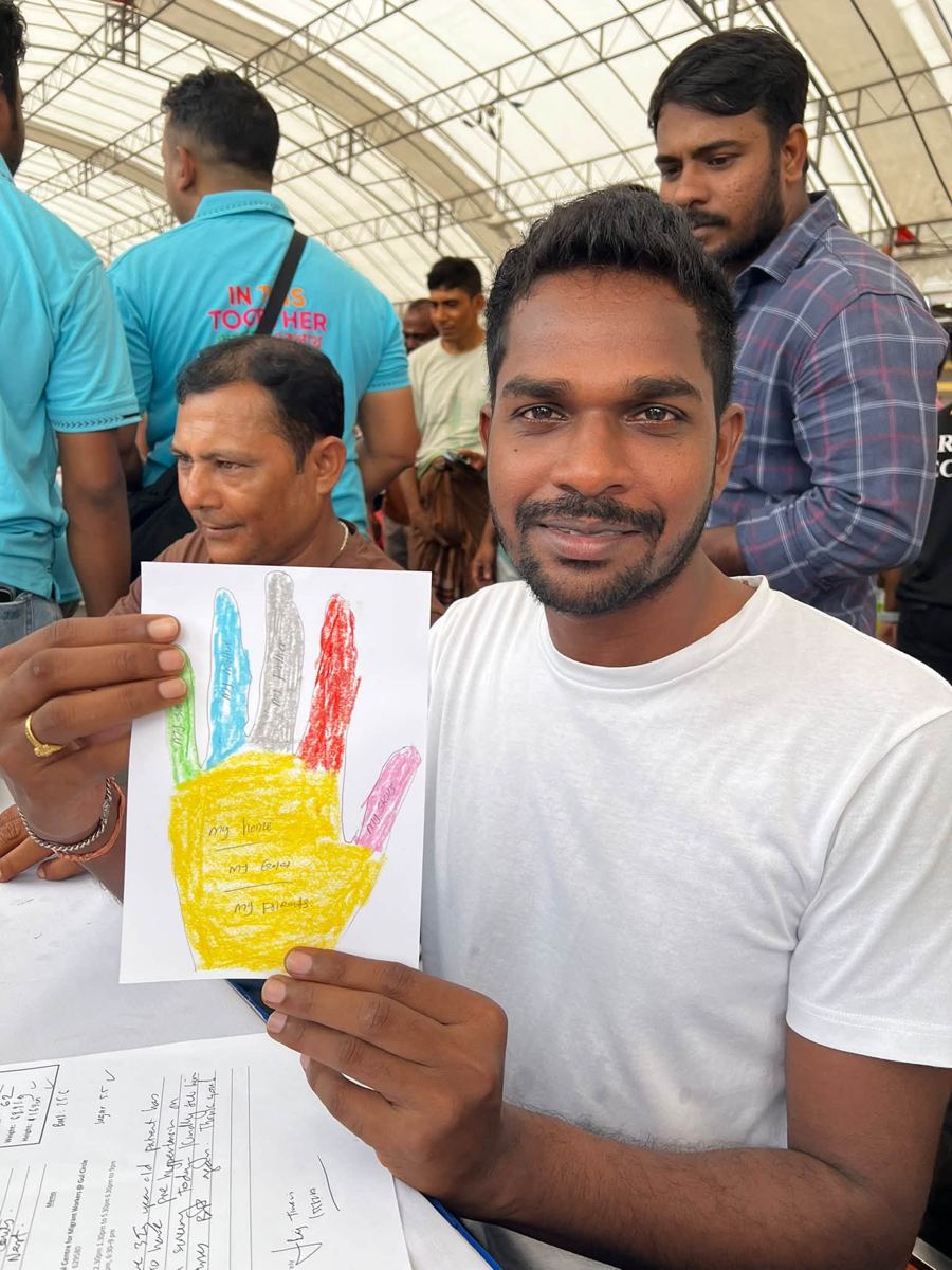 Portrait of [NAME] holding their artwork