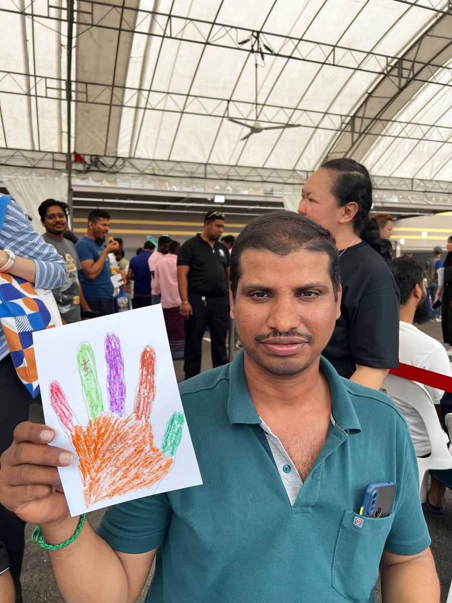 Portrait of [NAME] holding their artwork