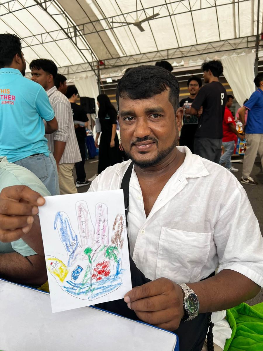 Portrait of [NAME] holding their artwork