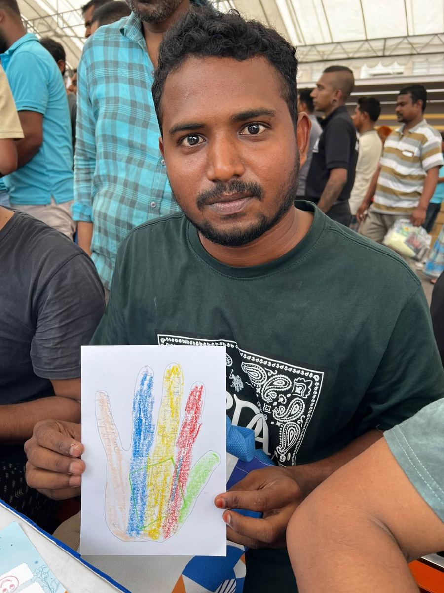 Portrait of [NAME] holding their artwork