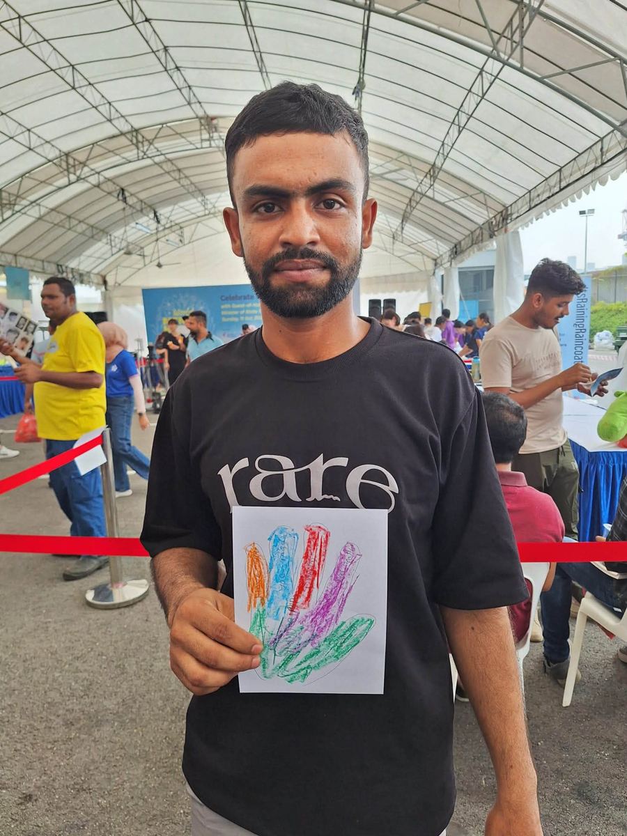 Portrait of [NAME] holding their artwork