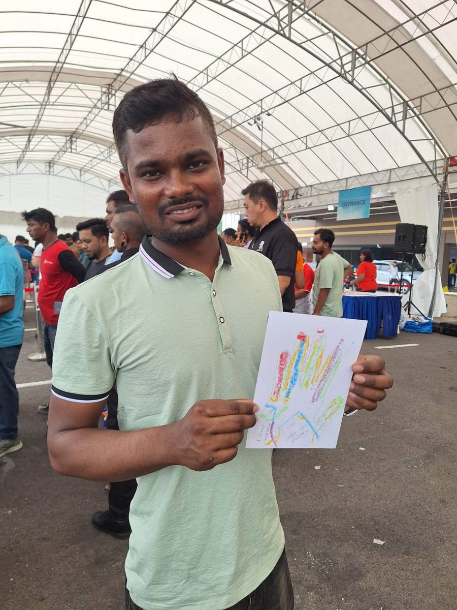Portrait of [NAME] holding their artwork