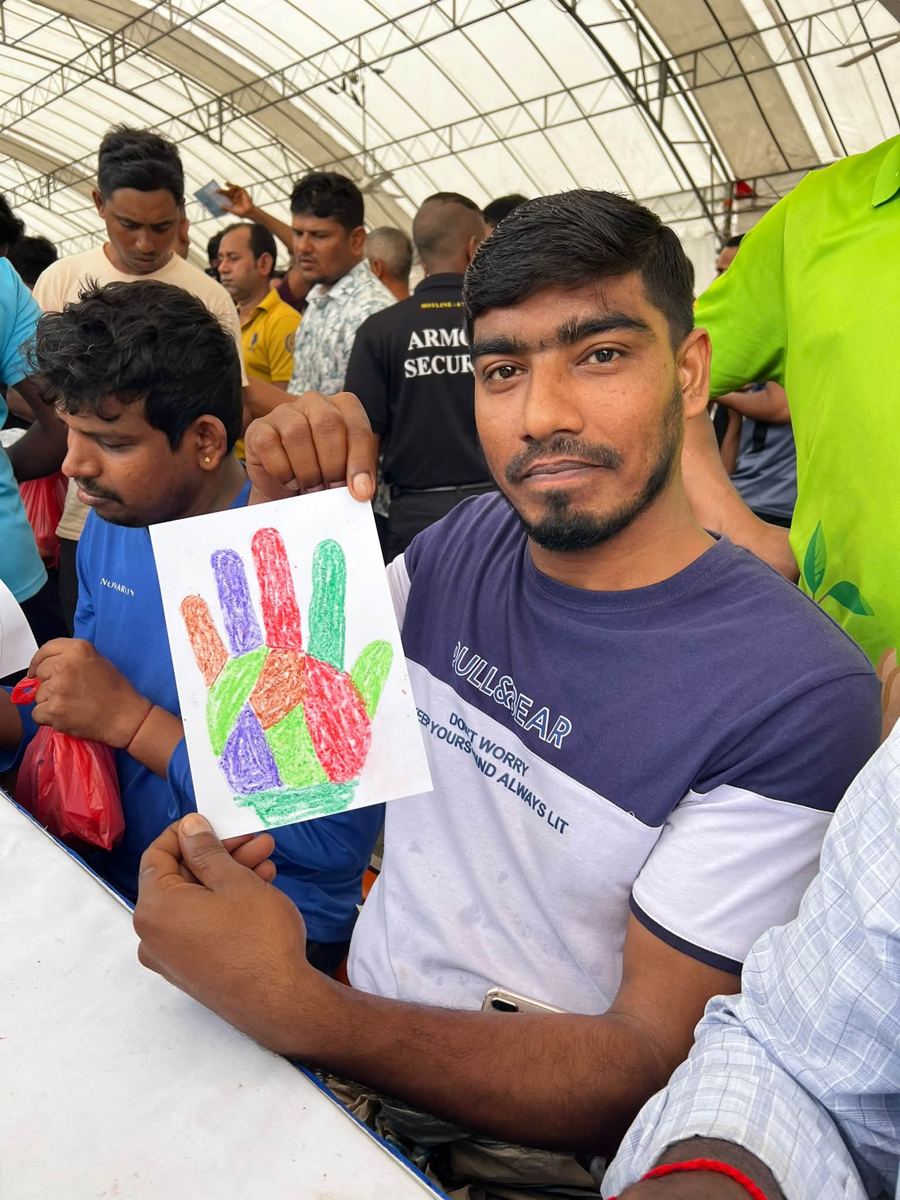 Portrait of [NAME] holding their artwork