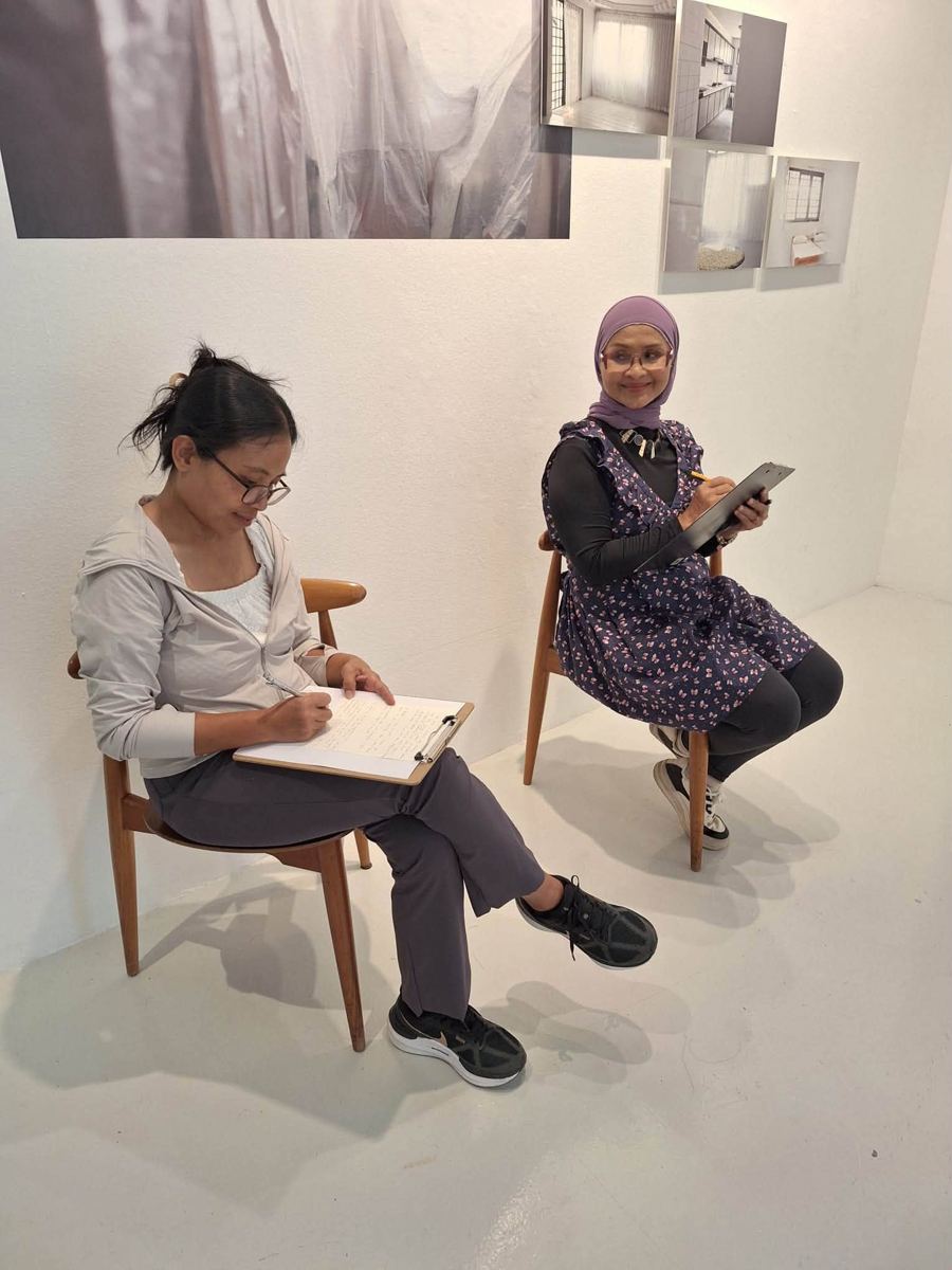 Participant writing at an MWS workshop, [NAME / DESCRIBE]