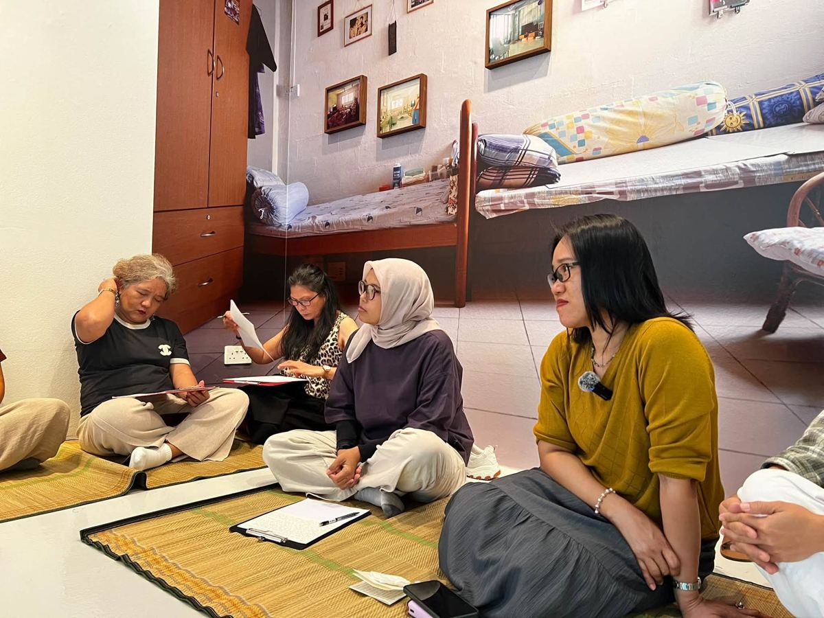 Participant writing at an MWS workshop, [NAME / DESCRIBE]