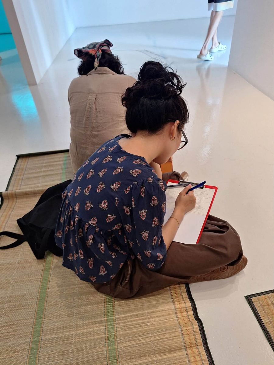 Participant writing at an MWS workshop, [NAME / DESCRIBE]