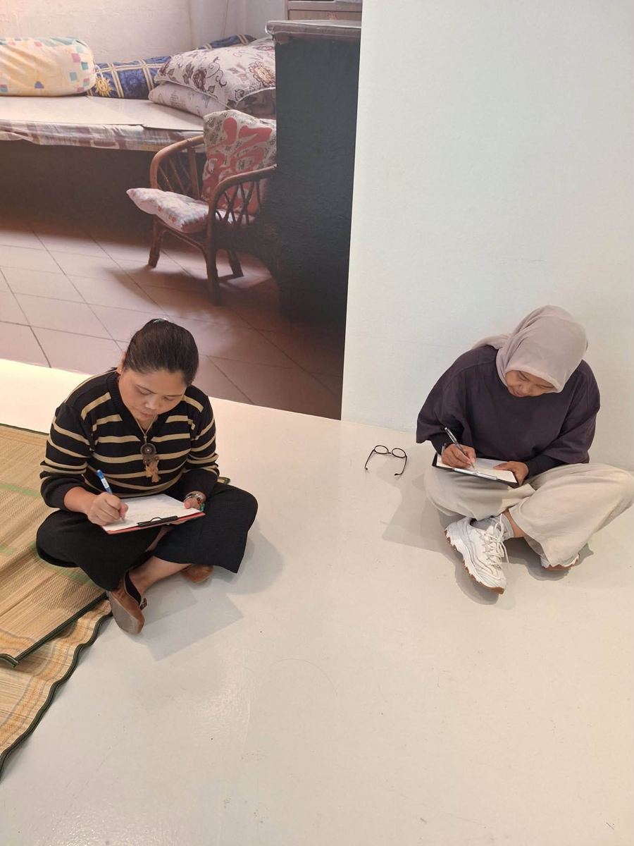 Participant writing at an MWS workshop, [NAME / DESCRIBE]